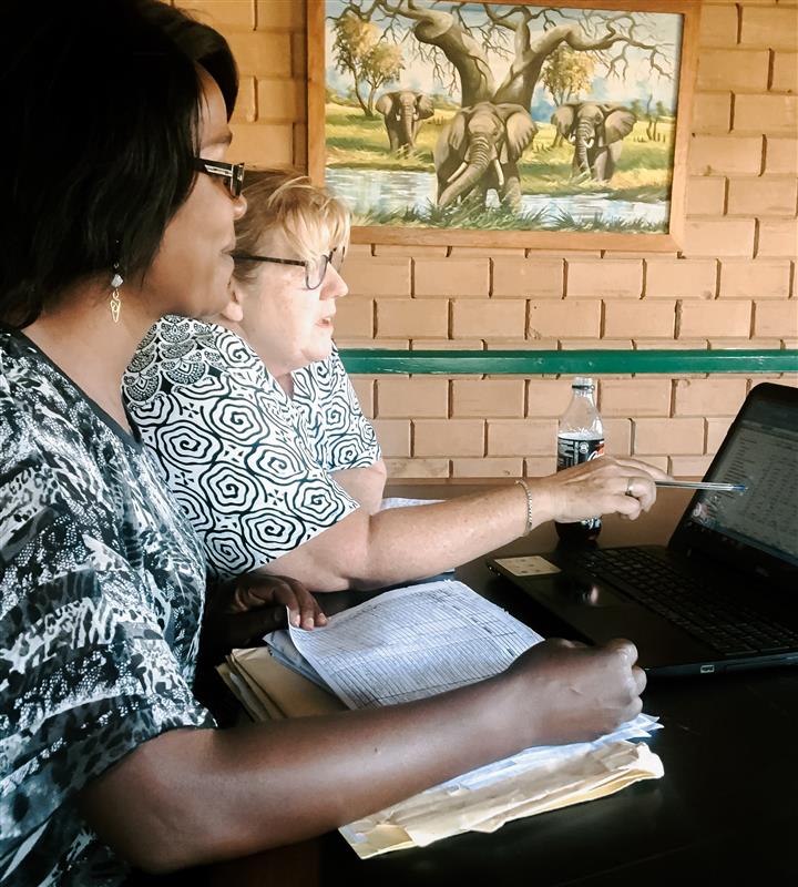 Two people working together on a computer.