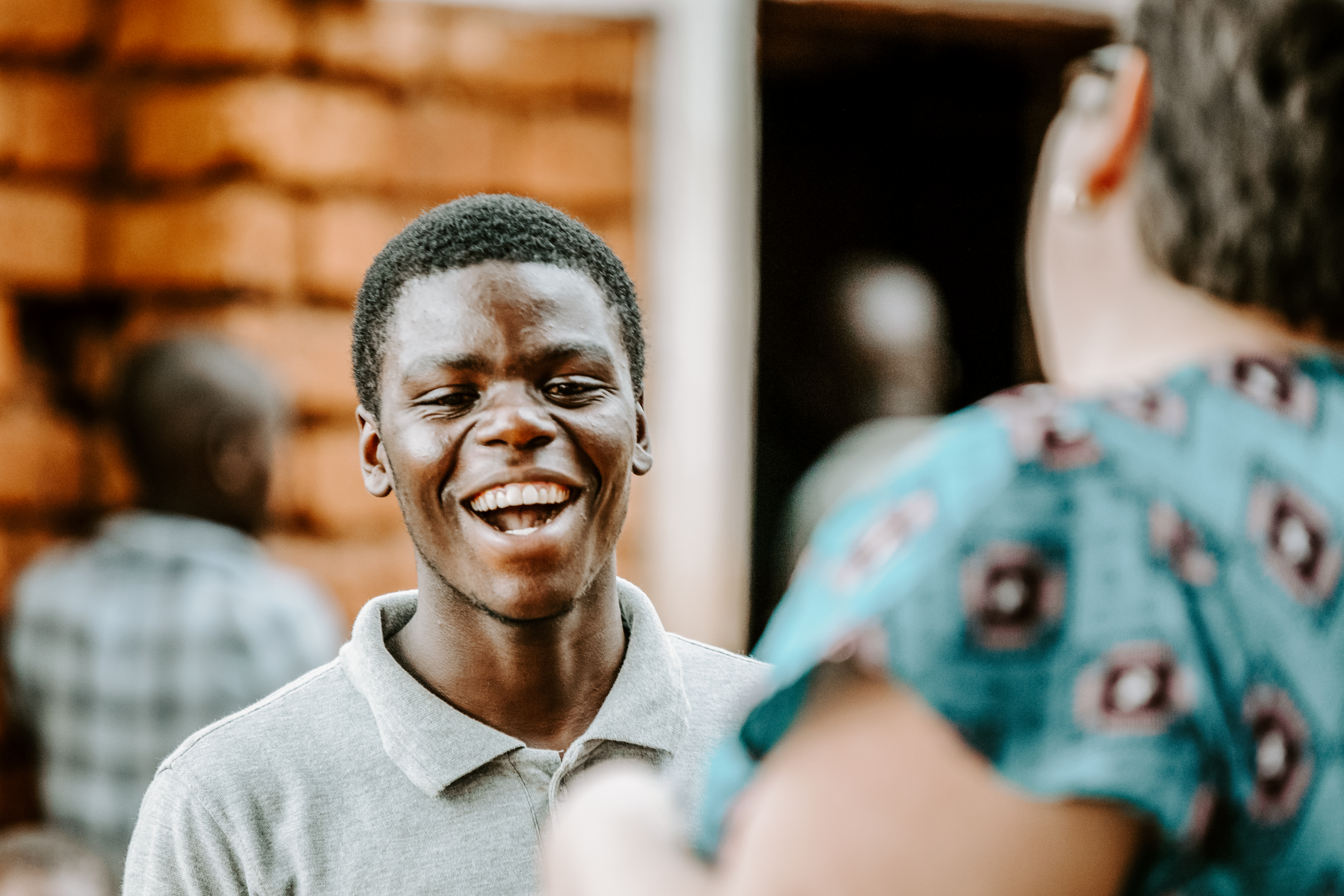 A group of students and their teacher planting a tree