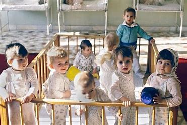Photos of orphans in a playpen