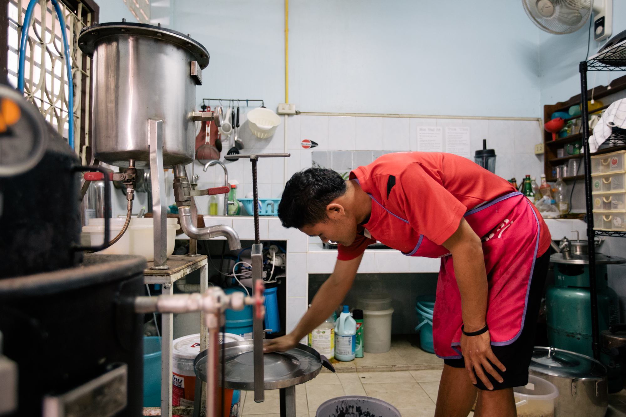 Photo of a man cleaning in the kitchen from Imagine Thailand