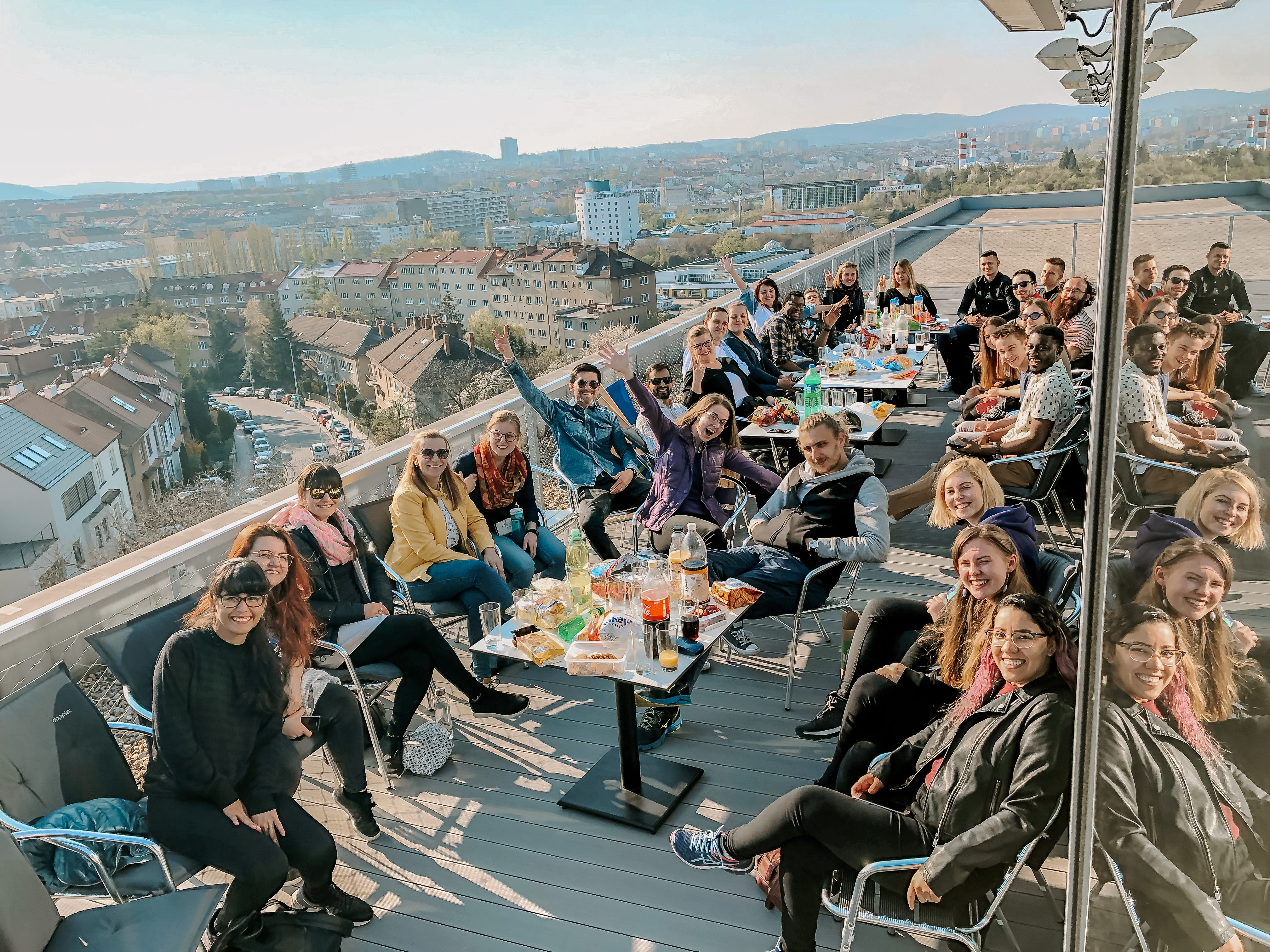 Youth group eating dinner on a roof