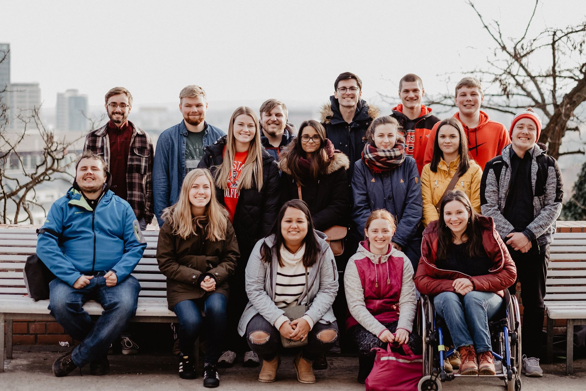 Youth group sitting on a bench on a day trip
