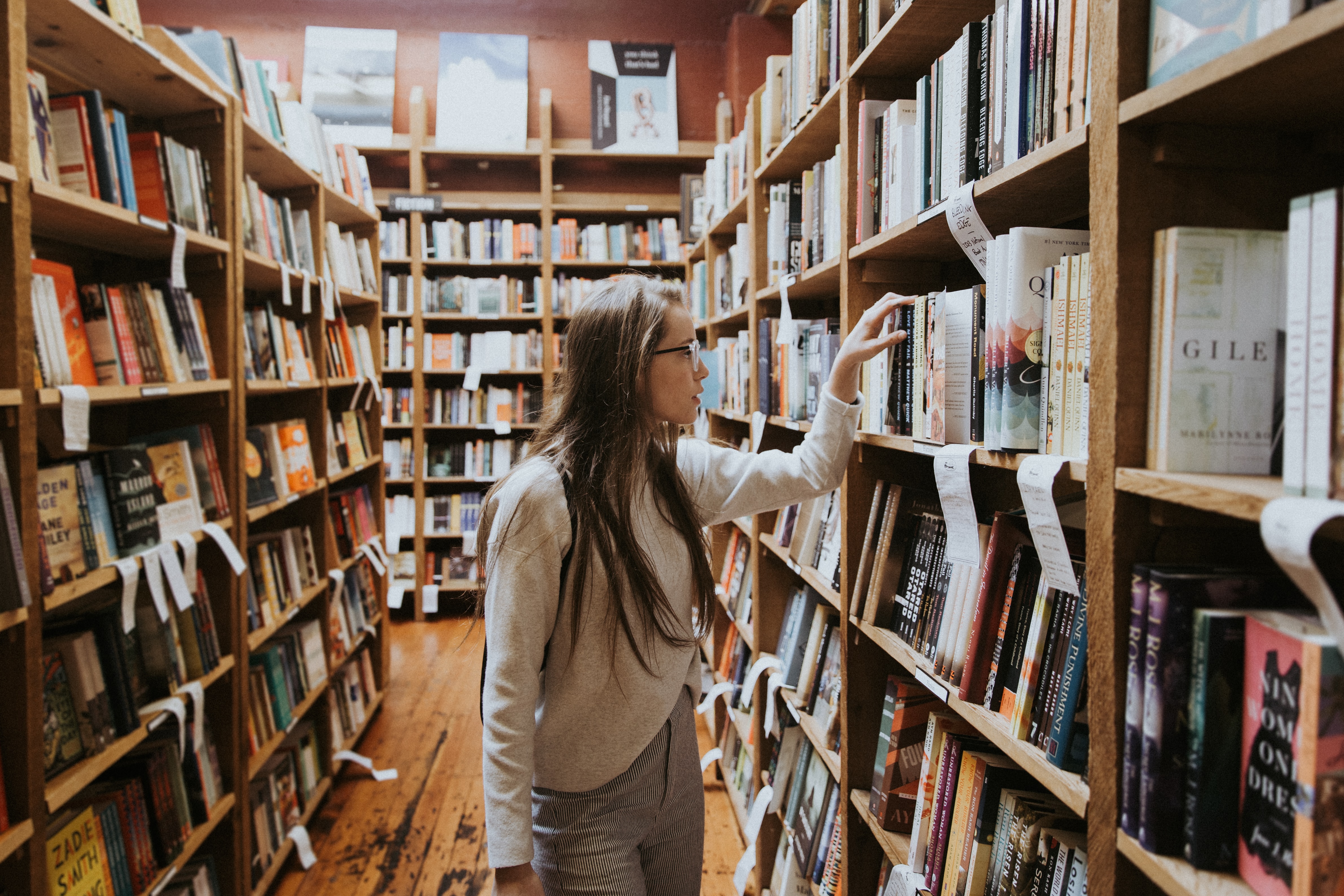 Photo by Becca Tapert on Unsplash of a girl in the library