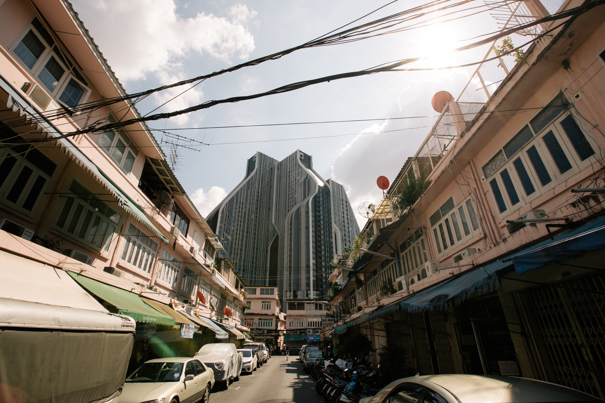 Photo of a street in Thailand with buildings on both sides by Imagine Thailand