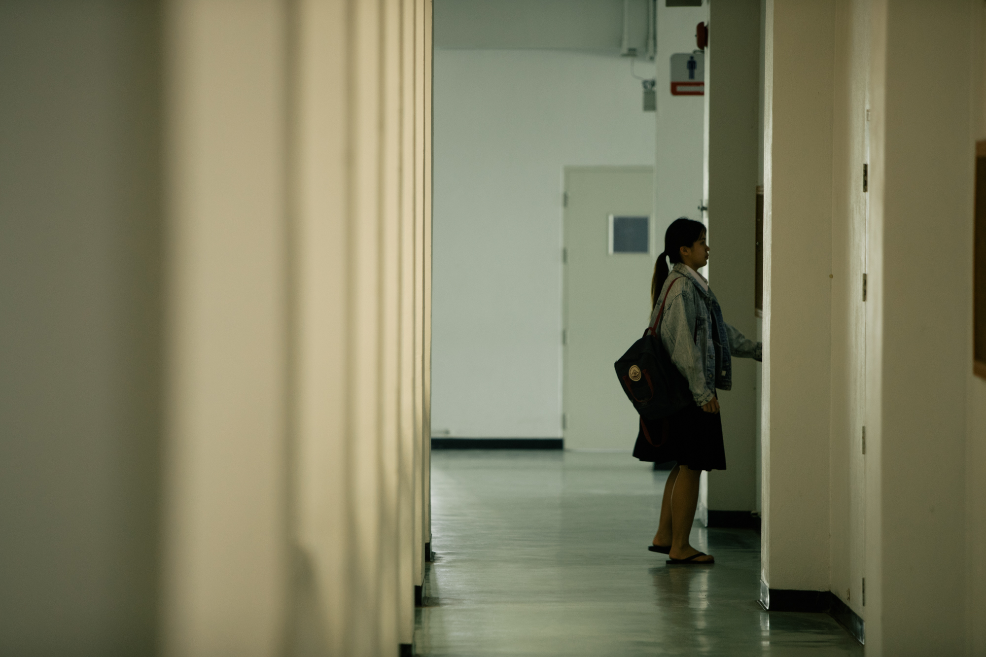 Photo of a girl standing in front of a door by Imagine Thailand