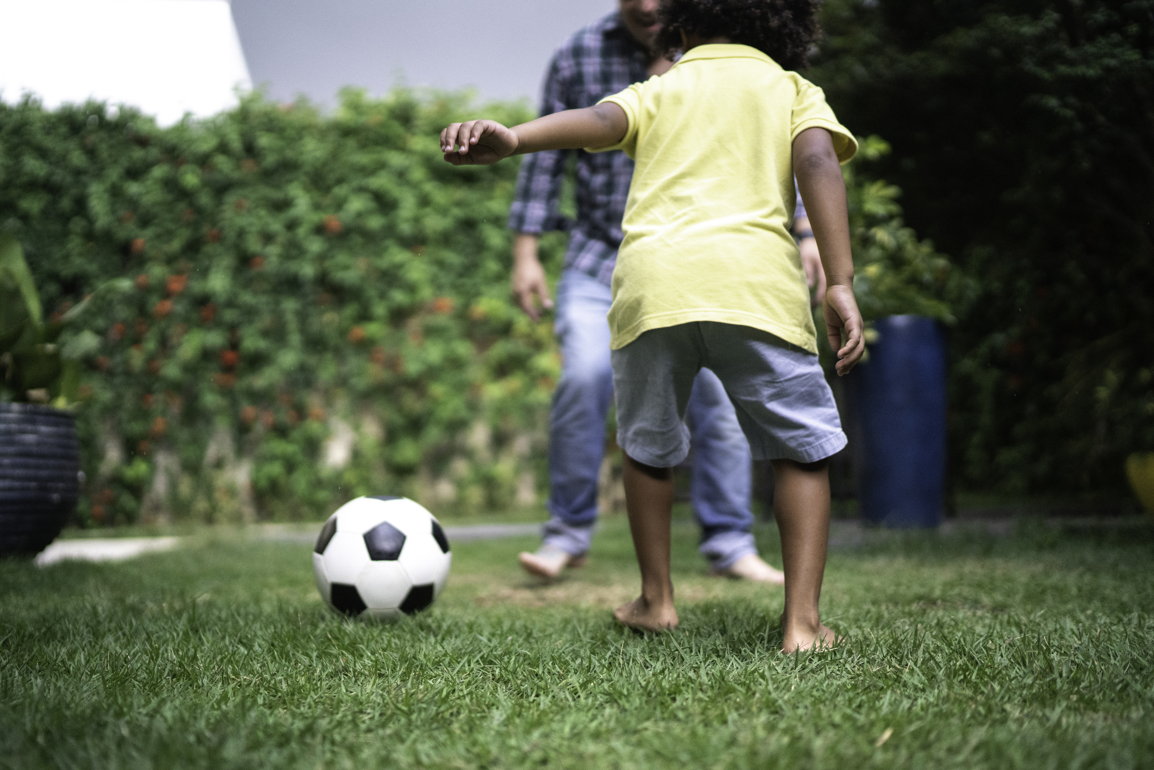Father Playing Soccer with Child
