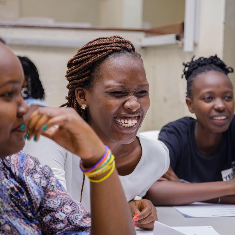 3 girls in classroom laughing