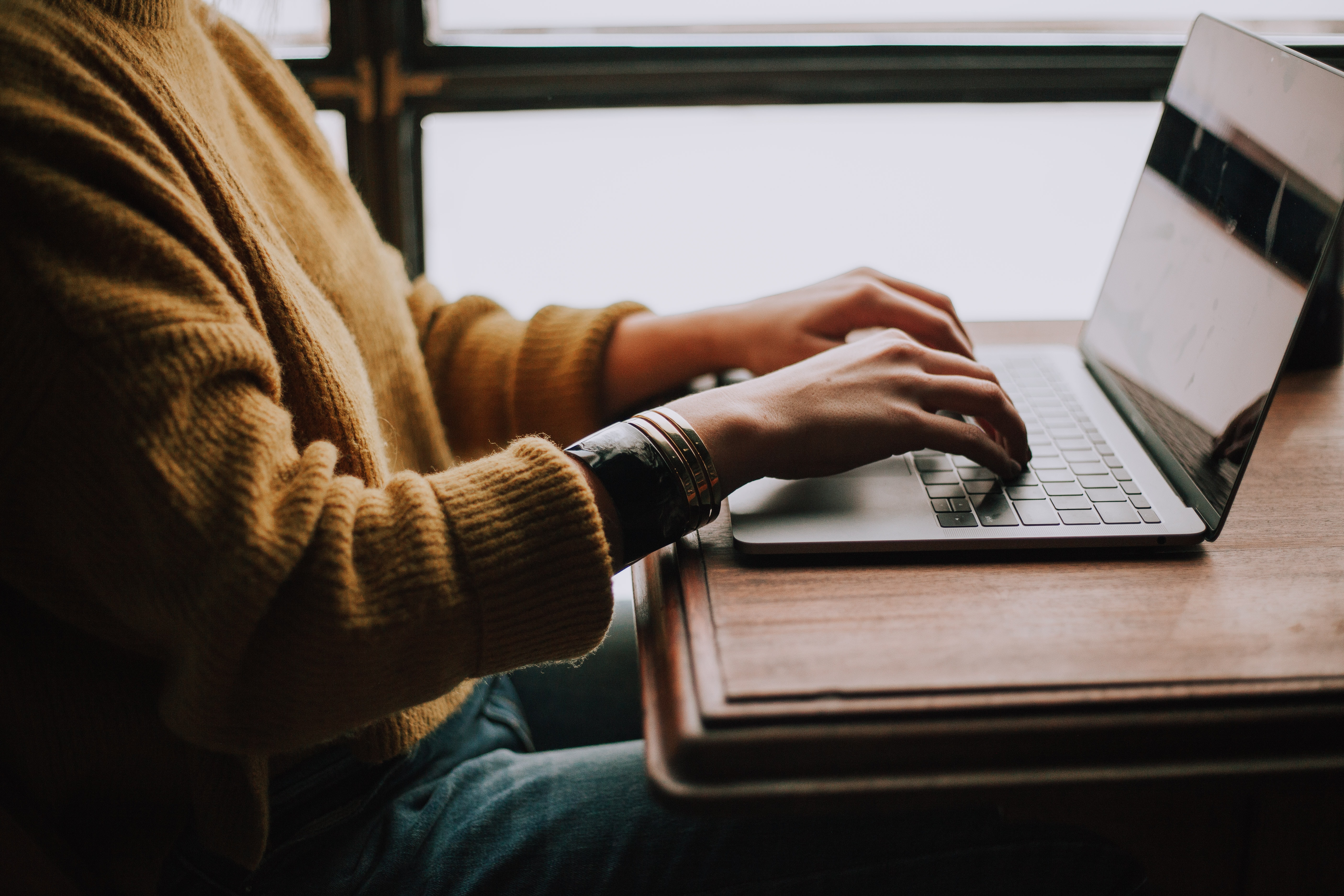 Photo of someone working on a laptop by Christin Hume on Unsplash.