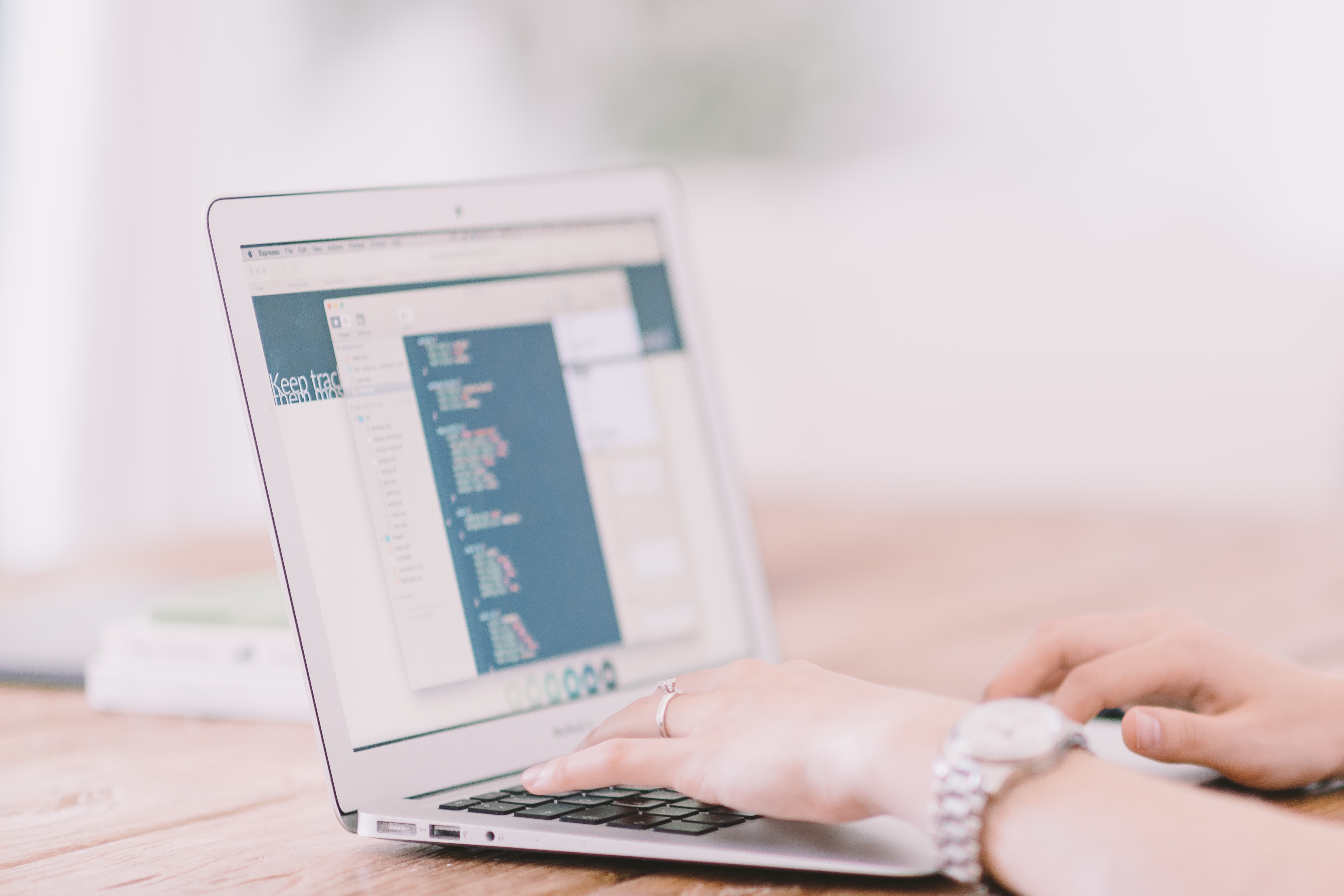 Photo by Crew on Unsplash of a person using a laptop.