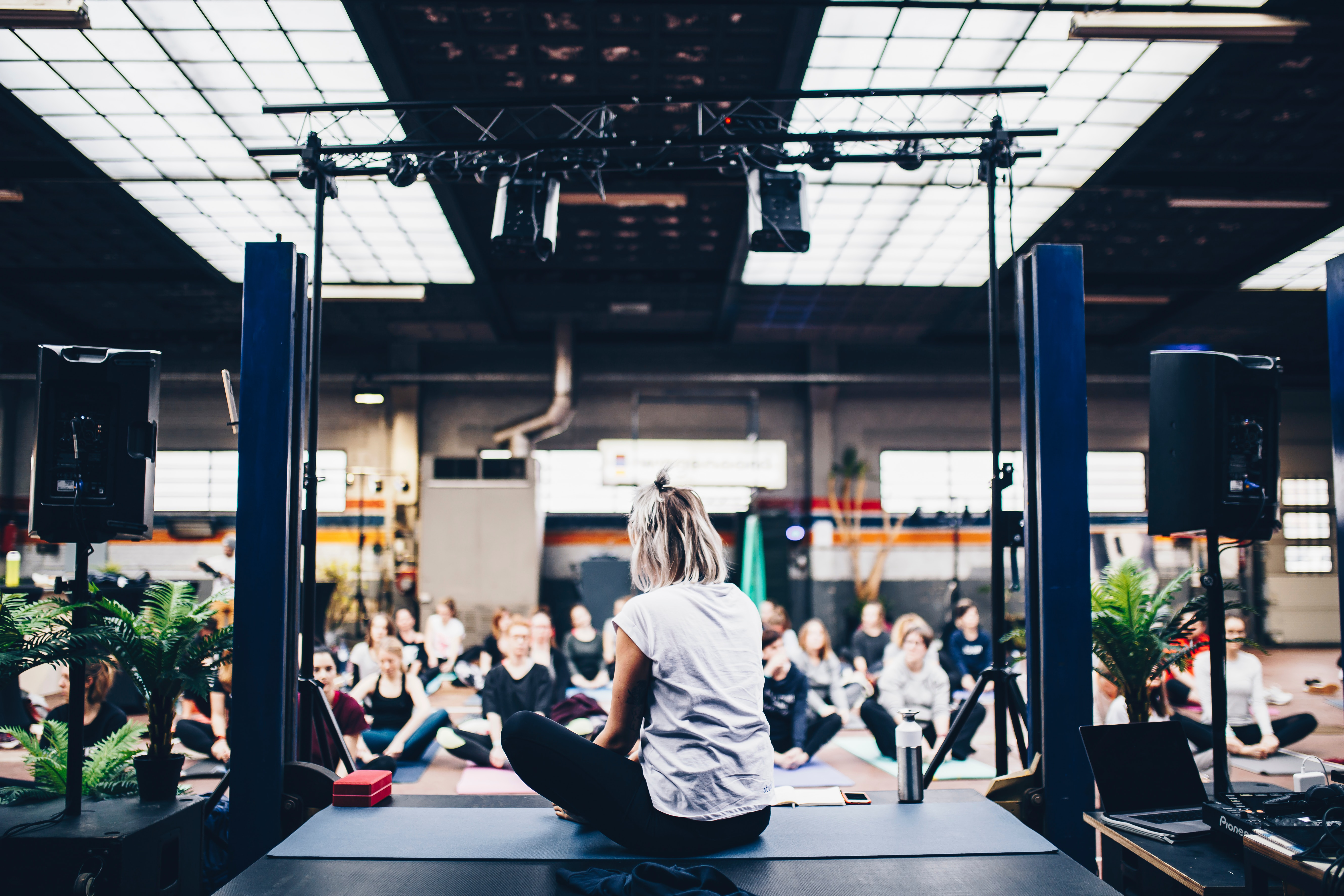 Photo by Geert Pieters on Unsplash of a yoga instructor teaching a class.