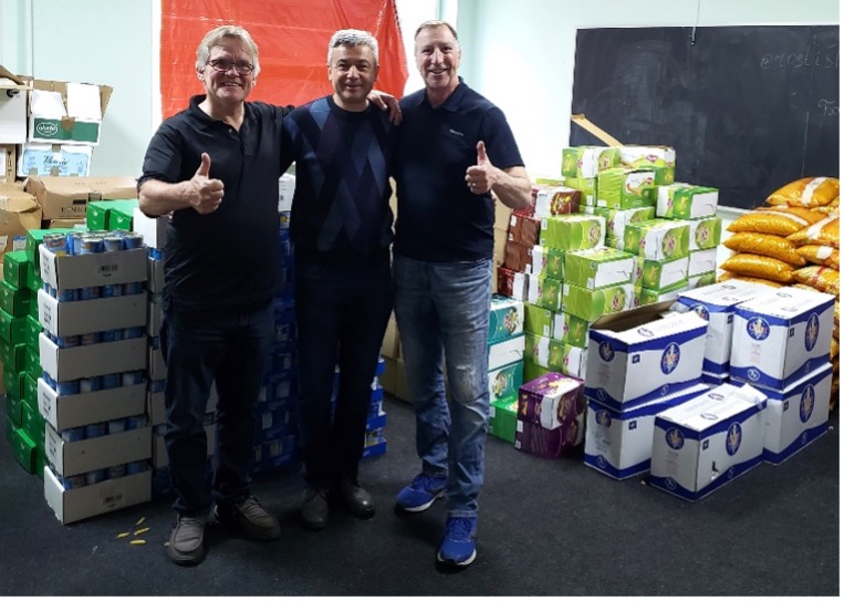 Steven Hertzog with Ed & Volodya Saladyuk (LTS President) sorting food for delivery to war zone