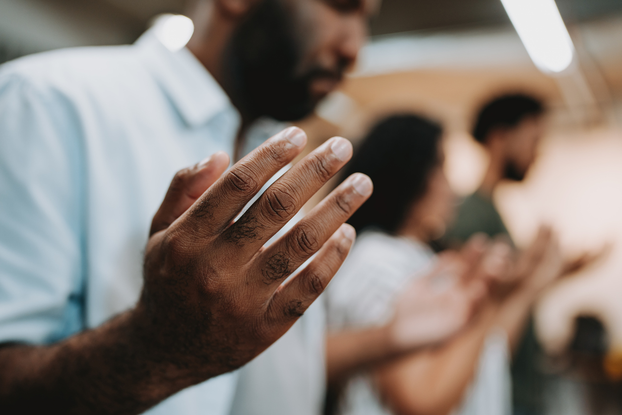 5 - For the Web - Landing Page - Every Church a House of Prayer - iStock-1708306721 A man holding his hands up in prayer.