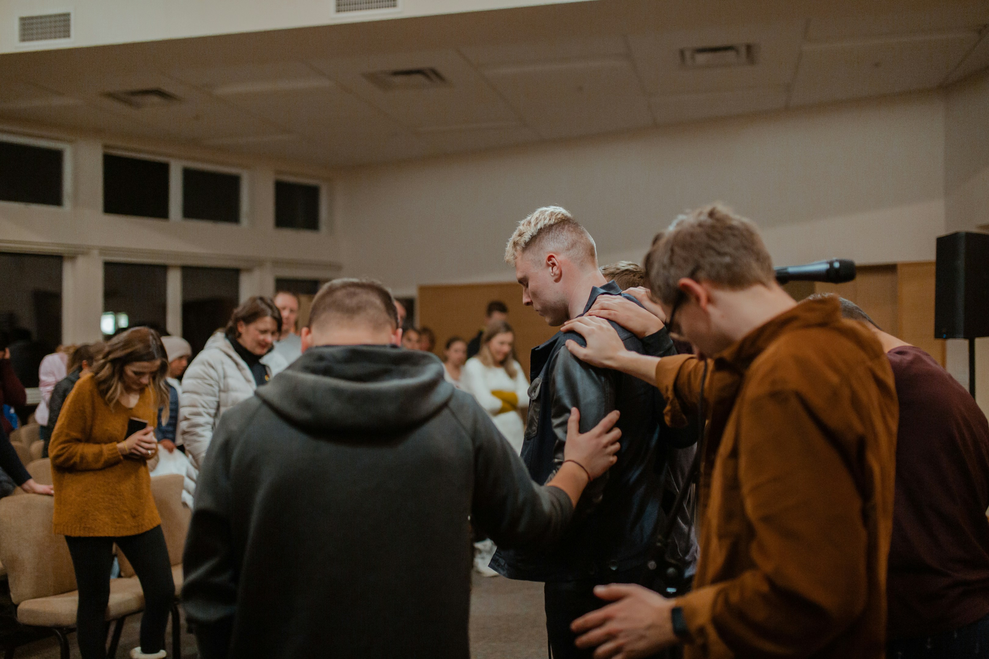 A group of people praying together.