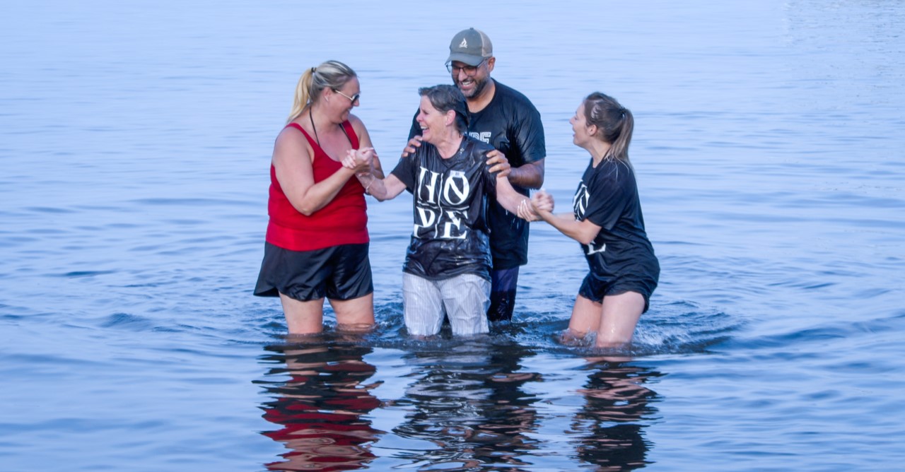 Photo 2 A woman getting baptized at Church at the Beach.