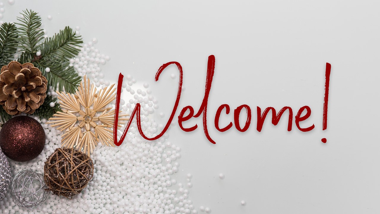 Stock photo of minimalist Christmas greenery/decor with the text "Welcome" displayed