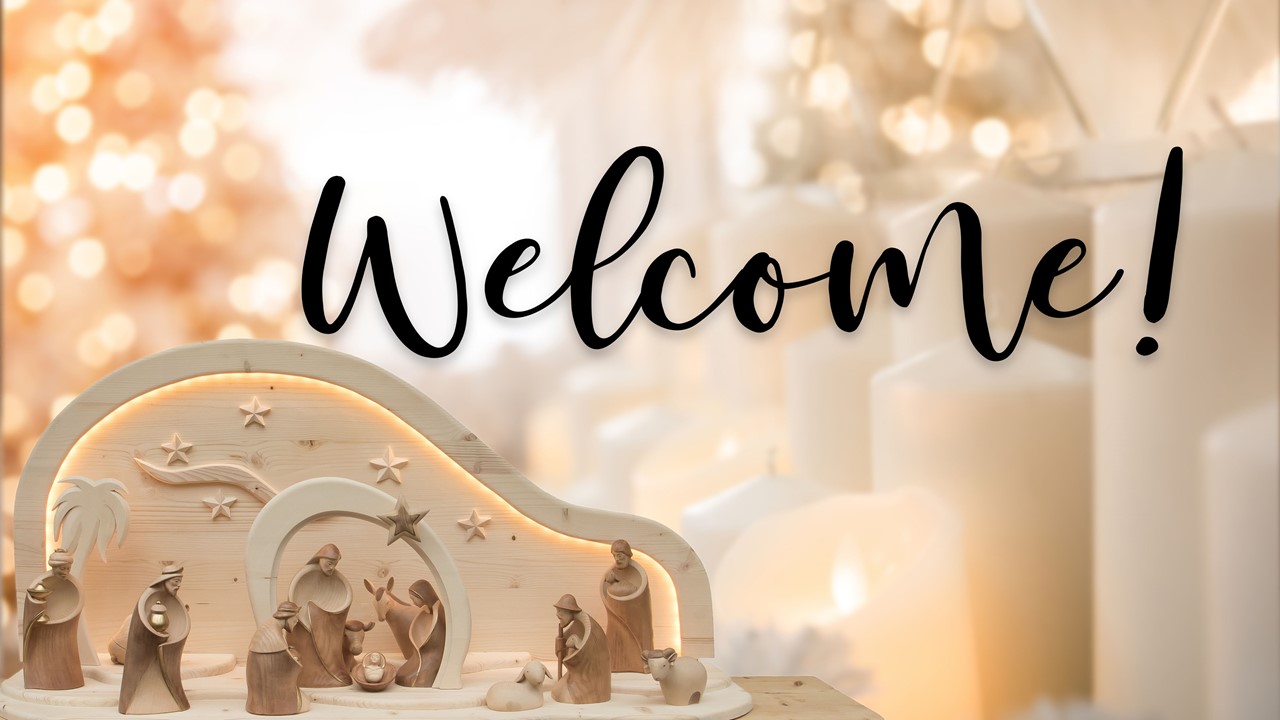 Stock image of a Nativity scene made of wooden figures, with the words "Welcome" displayed