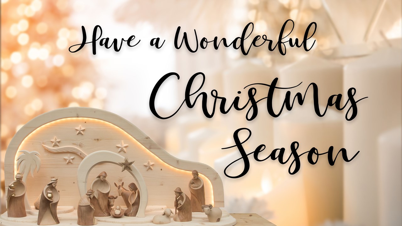 Stock image of a Nativity scene made of wooden figures, with the words "Have a wonderful Christmas season" displayed